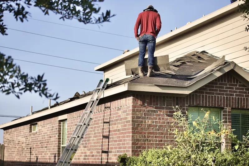 Professional roofer working on a residential roof in Sagamore Beach